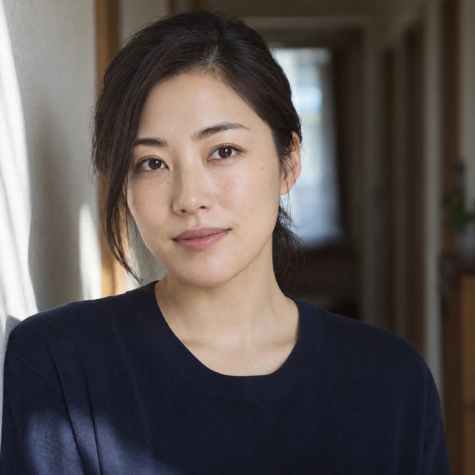 Natural portrait of a woman with a hand near her hair