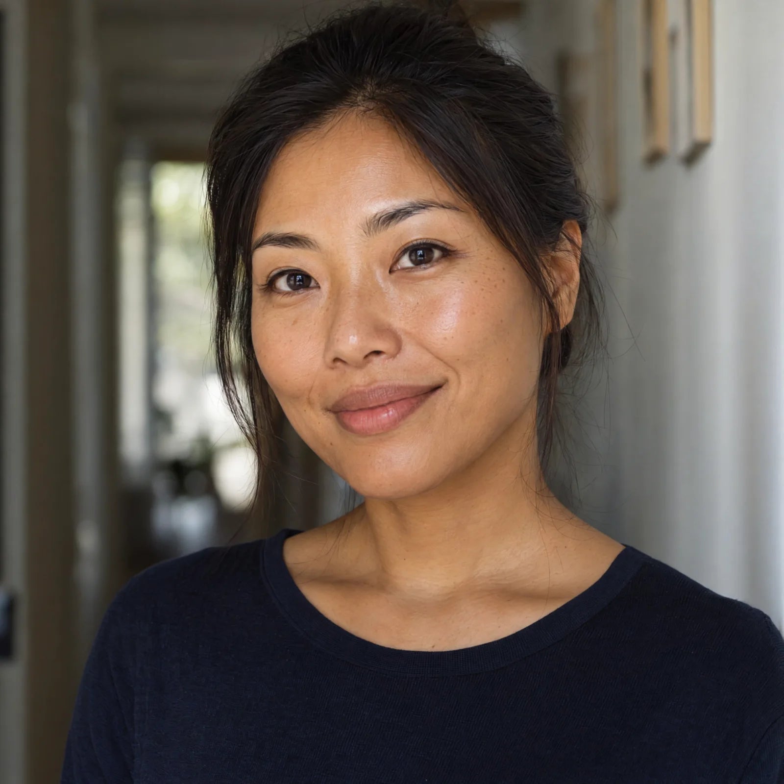 Natural portrait of a woman with a hand near her hair